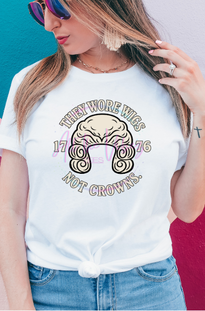 Woman wearing a white shirt that says, They Wore Wigs not Crowns