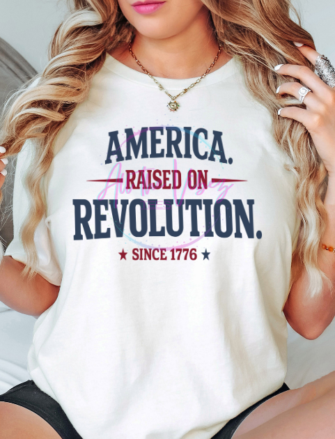 Woman wearing America Raised on Revolution progressive Americana graphic tee