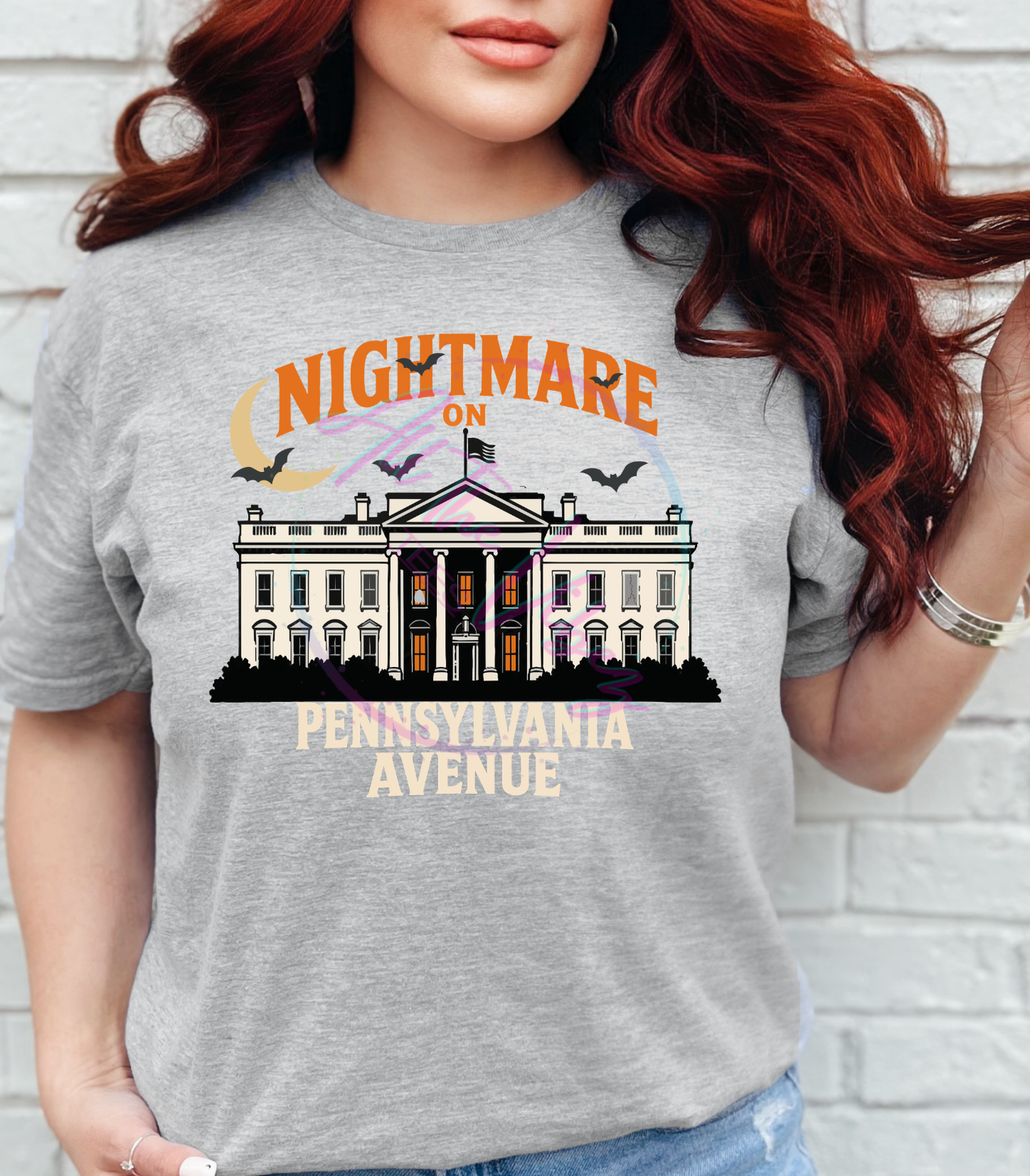 Woman wearing Nightmare on Pennsylvania Avenue political Halloween graphic tee featuring a haunted White House illustration.