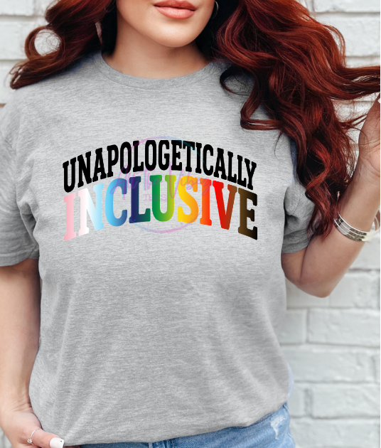 Woman wearing Unapologetically Inclusive rainbow progressive pride graphic tee