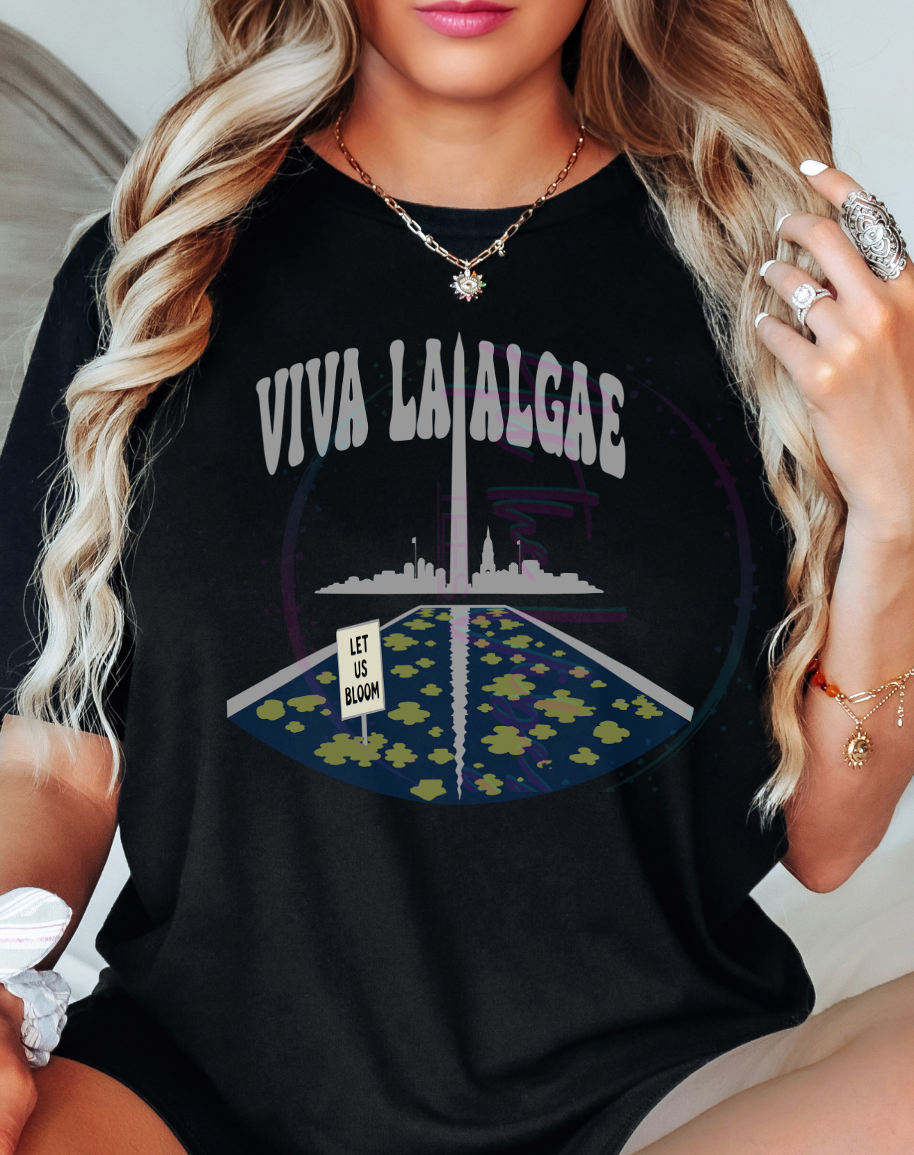 Person wearing a black t-shirt with 'VIVA LAI ALGAE' text and graphic design.